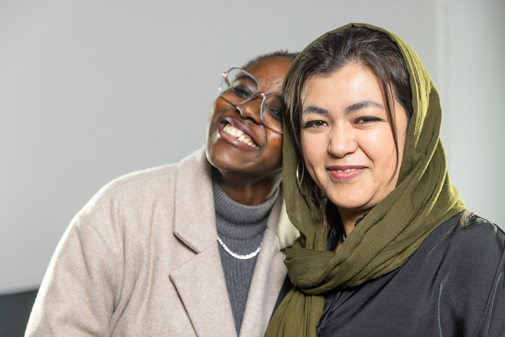 Two young women pose for the camera.