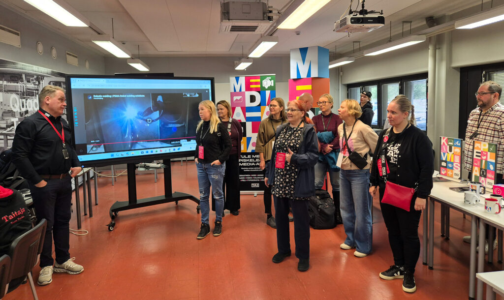 Opot kuuntelevat automaatioalan opettajien puhetta työpajassa.